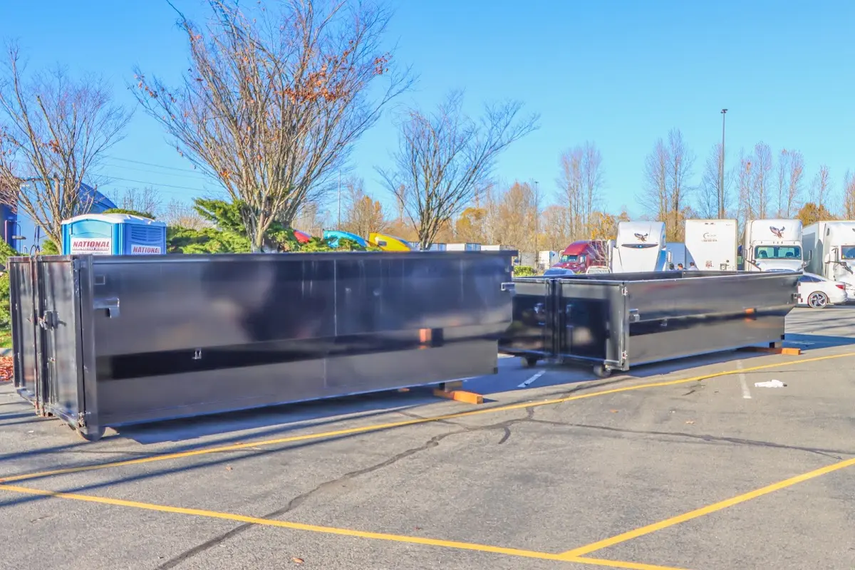 Professional dumpster rental service with roll-off container on residential driveway in Little Ferry